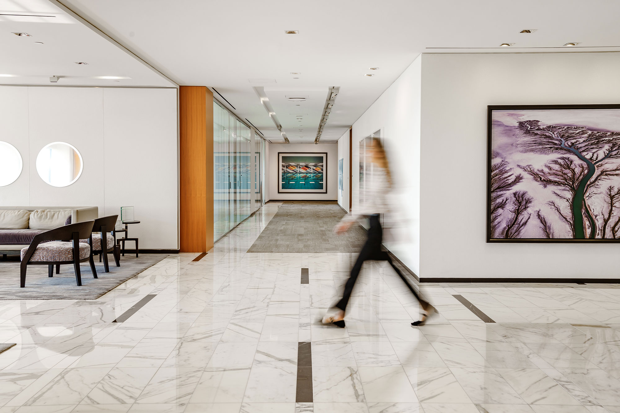 A lawyer walks through a lobby in Osler's office.